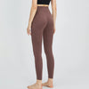 A model wearing high-waist seamless yoga leggings in a dusty rose color.