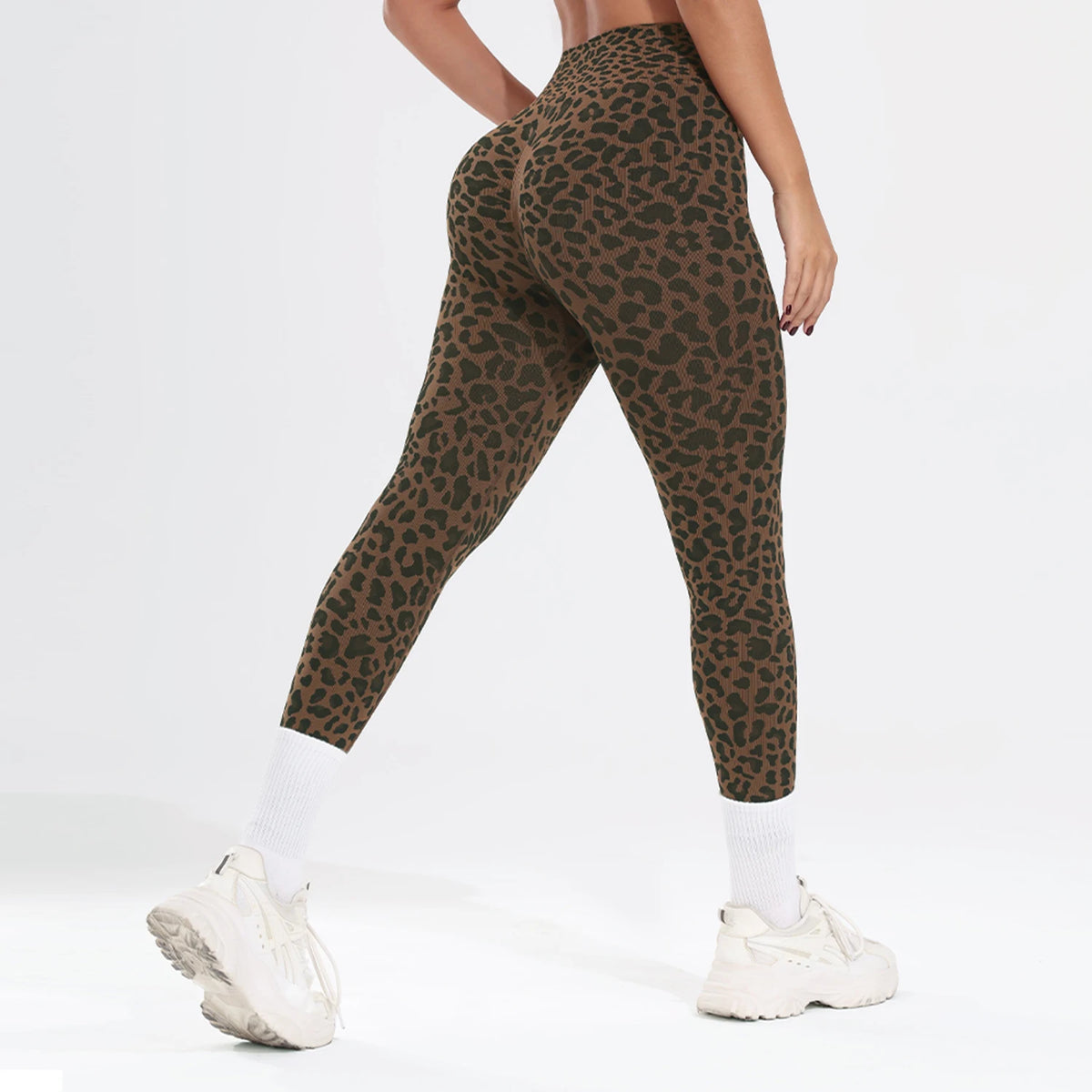 A model wearing a leopard print seamless two-piece sports set featuring leggings and a top.