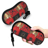 A black and red spider web patterned pouch for eyeglasses being held by a hand.