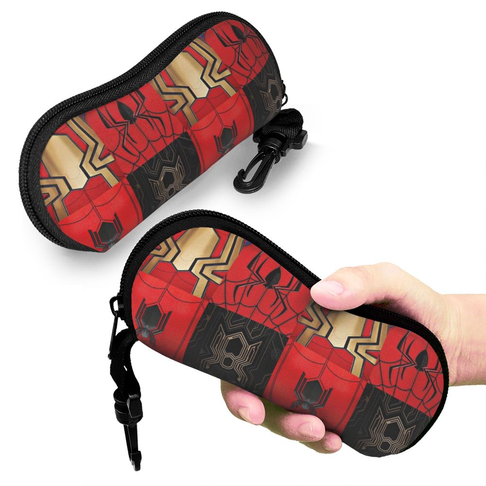 A black and red spider web patterned pouch for eyeglasses being held by a hand.
