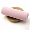 Pink elastic band rolled up on a wooden surface
