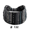 A black and gray knitted headband with a geometric pattern for yoga or workout.