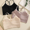 Three ribbed crop tops in black, lilac, and cream are displayed against a light background.