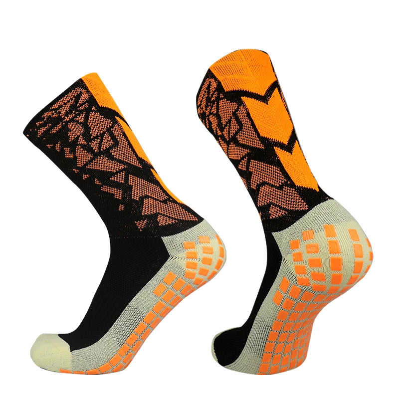 A pair of orange and black anti-slip training socks shown from the side.