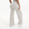 A person is modeling light beige NCLAGEN SoftMotion straight leg yoga pants.