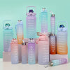 A collection of various leakproof sports water bottles in shades of purple, pink, and teal with straws.
