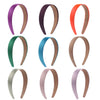 A collection of solid satin hair bands in various colors including purple, dark brown, orange, teal, beige, and pink.