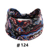 A black and blue boho print cotton headband tied in a bow.