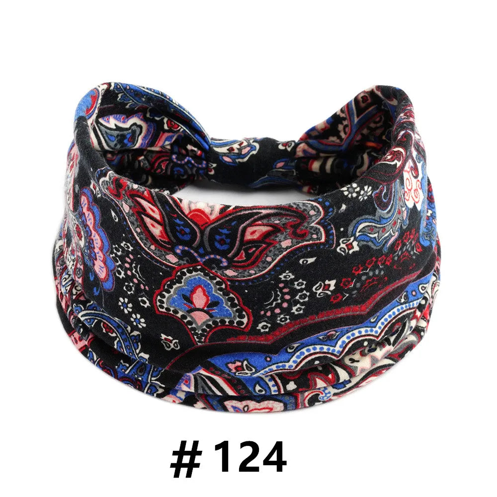 A black and blue boho print cotton headband tied in a bow.