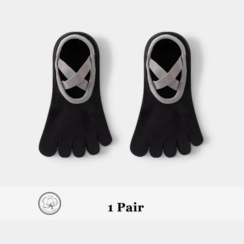 A pair of black five-finger invisible yoga and fitness socks with a silver crisscross design.