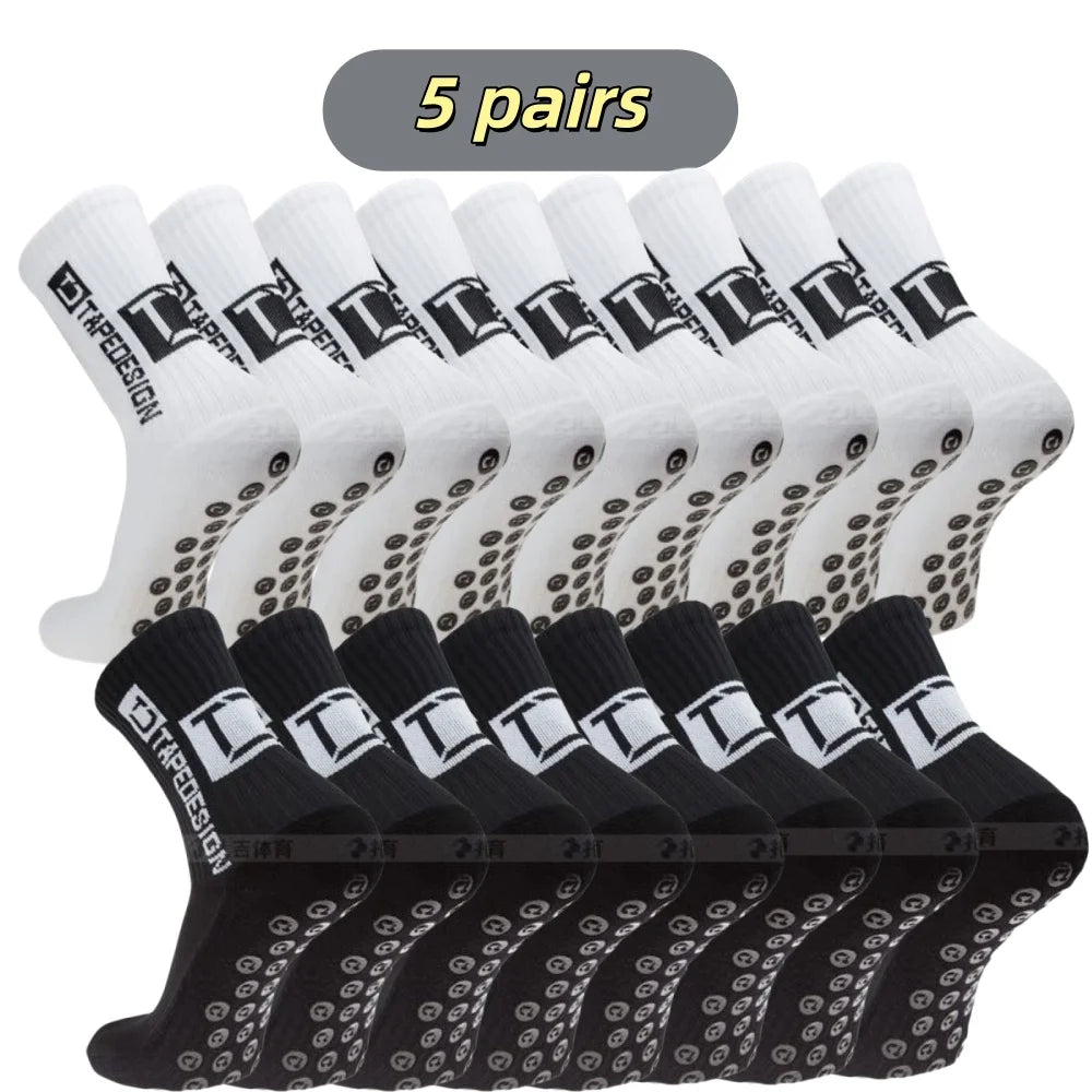 Five pairs of black and white mid-calf football socks are displayed in a row.