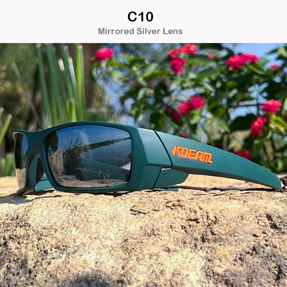 A pair of dark green mirrored silver lens sunglasses resting on a rough, light-colored rock outdoors.
