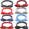 A collection of eight elastic hair headbands featuring various paisley patterns in red, black, white, and blue.