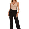 A woman models a nude full body shapewear bodysuit and black pants with sunglasses.