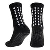 A pair of black multi-sport athletic grip socks shown from the side.