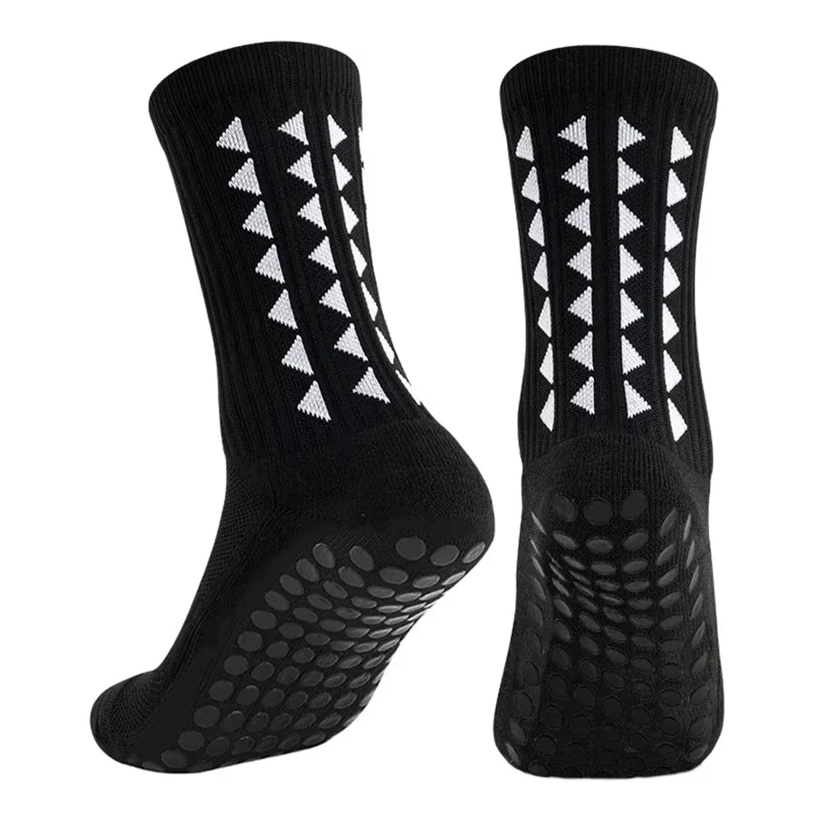 A pair of black multi-sport athletic grip socks shown from the side.