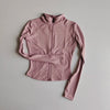 A light pink long-sleeved zip-up jacket for yoga and fitness.
