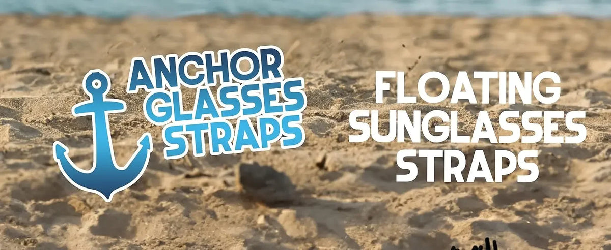 Anchor glasses straps and floating sunglasses straps displayed on a sandy beach near the ocean.