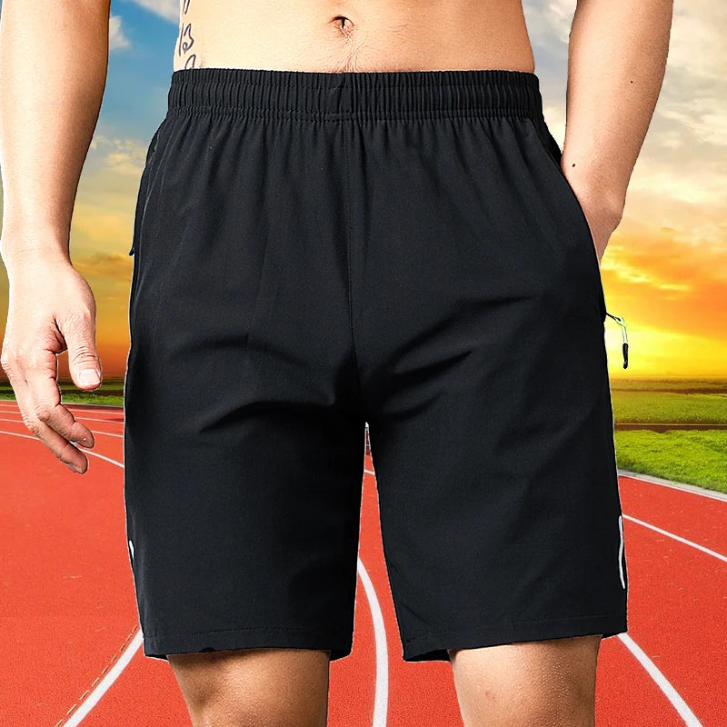 Black men's quick dry jogging shorts worn by a person on a running track.