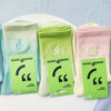 A set of three pastel green and pink socks displayed next to their packaging.