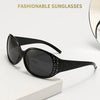 Black fashionable sunglasses with diamond-inlaid detailing displayed on a white surface.