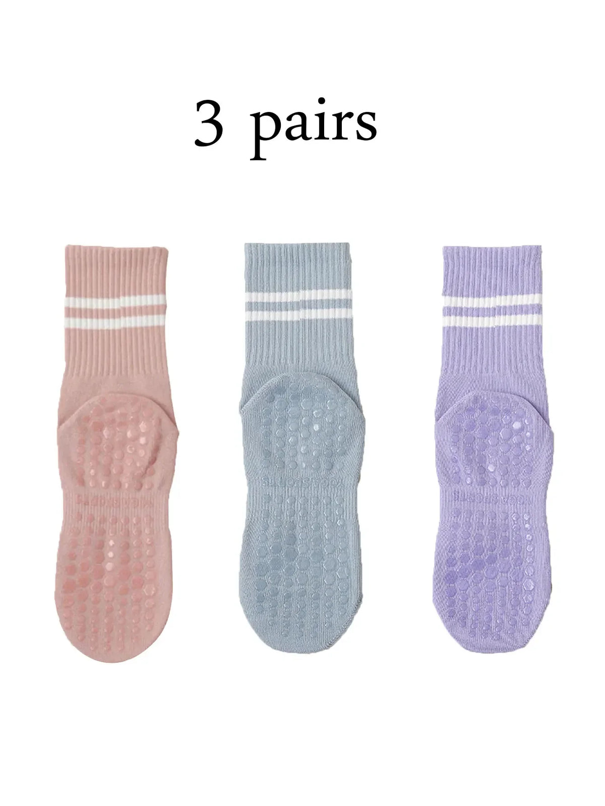 Three pairs of pink, light blue, and purple Pilates grip socks for yoga and barre