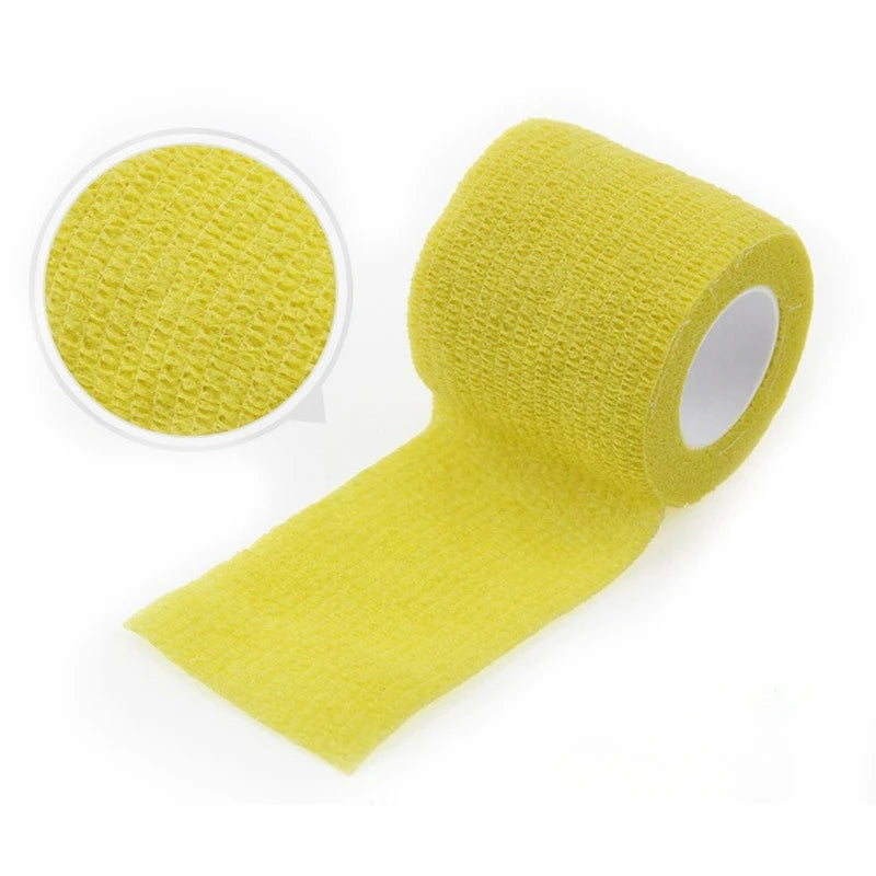 Yellow self-adhesive elastic bandage tape rolled and a circular piece shown on a white background