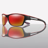 A pair of red-tinted polarized cycling sunglasses shown in a studio setting.