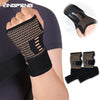 Black copper fiber wrist protector worn on a hand, showing the textured material and strap design.