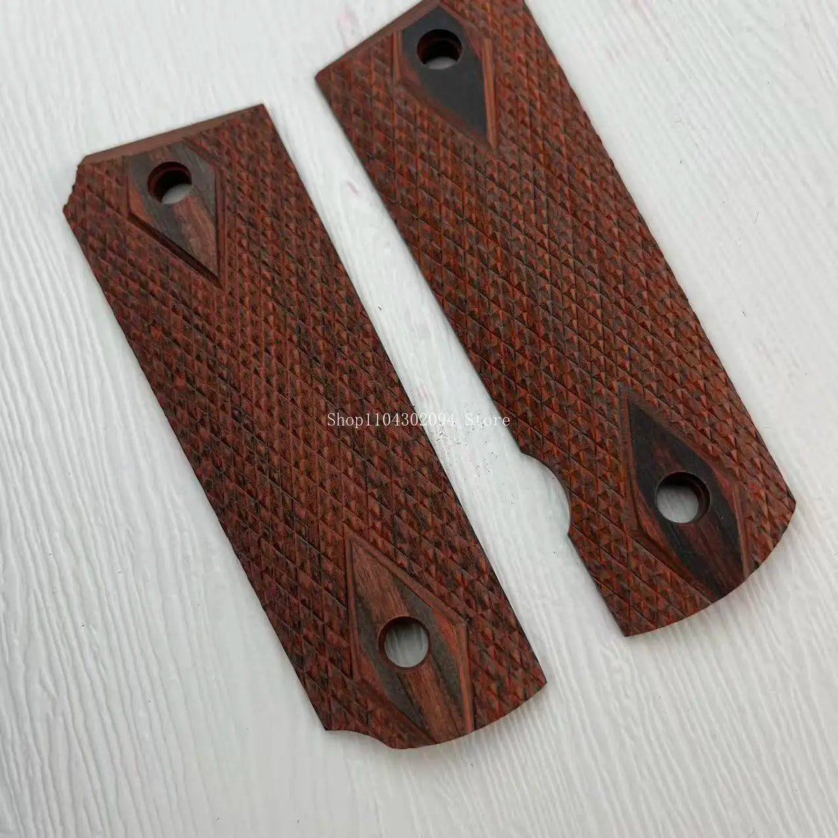 Two dark brown rosewood knife grip patches with decorative slots and a textured finish