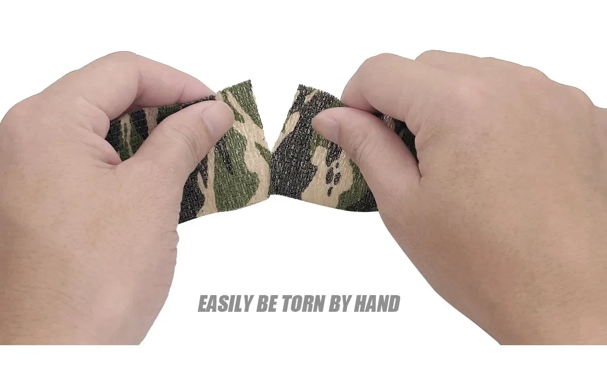 Hands tearing apart a piece of camouflage elastic wrap tape to demonstrate its strength.