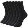 Une pile de chaussettes noires à col, vue de côté.