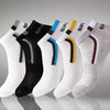 A row of men's color-block mesh ankle socks in various colors including black, white, blue, yellow, and maroon.