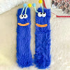 Pair of blue fuzzy plush caterpillar floor socks with yellow antennae and orange mouths