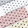 A set of four polka dot elastic hair bands in gray, white, pink, and cream colors.