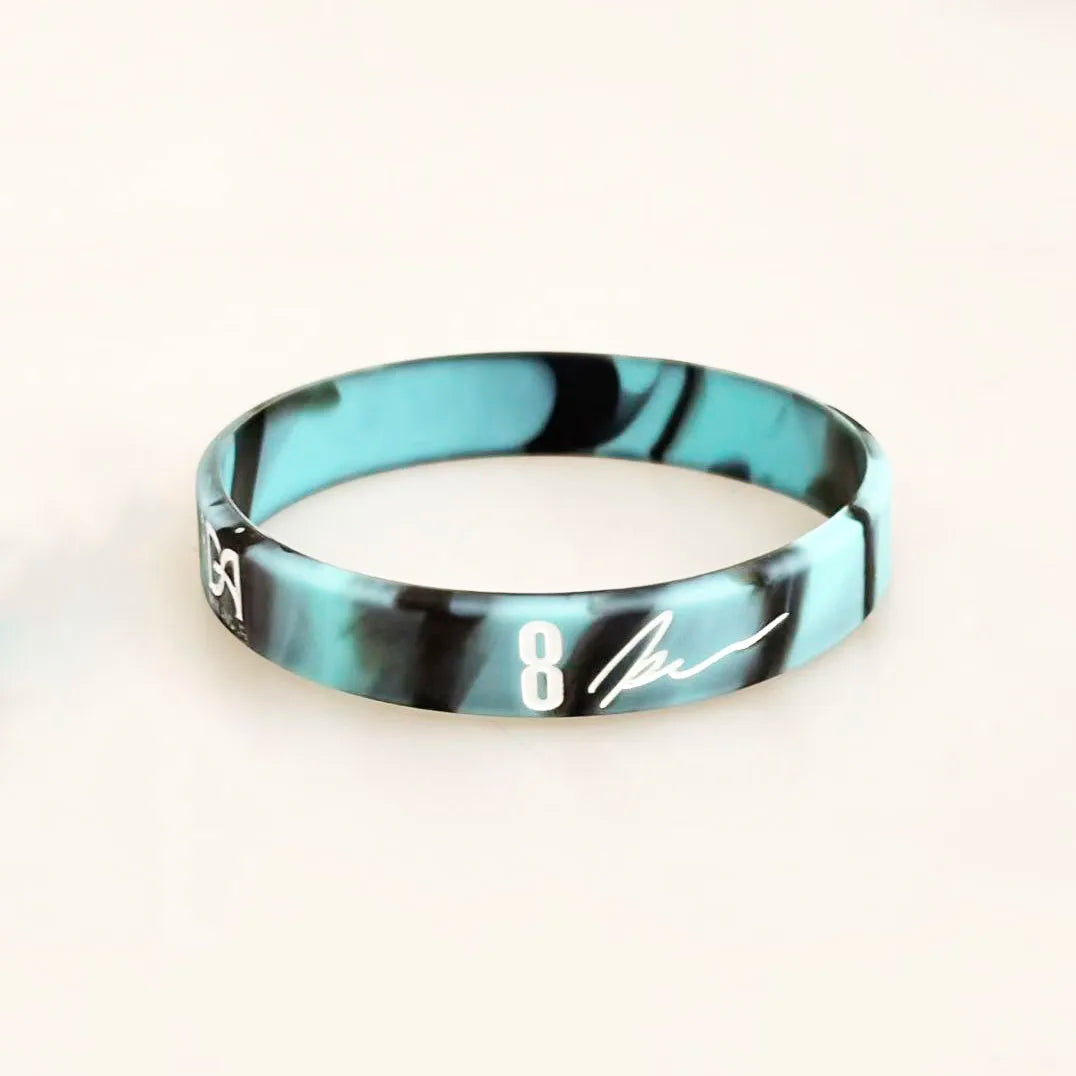 A black and teal marbled silicone wristband with the number 8 engraved on the front.