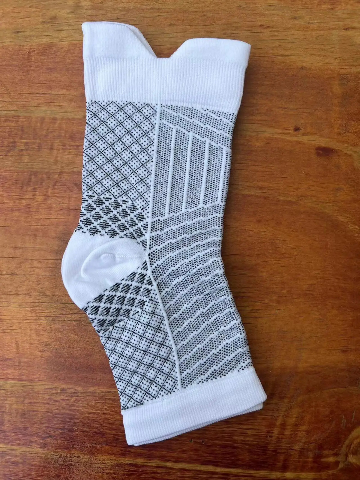 White and black therapeutic compression socks for foot and ankle pain relief