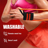 A person wearing a pink sports bra is using an orange wristband on their arm during a workout.
