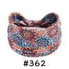 A close-up of a patterned orange and blue boho knotted cotton headband.
