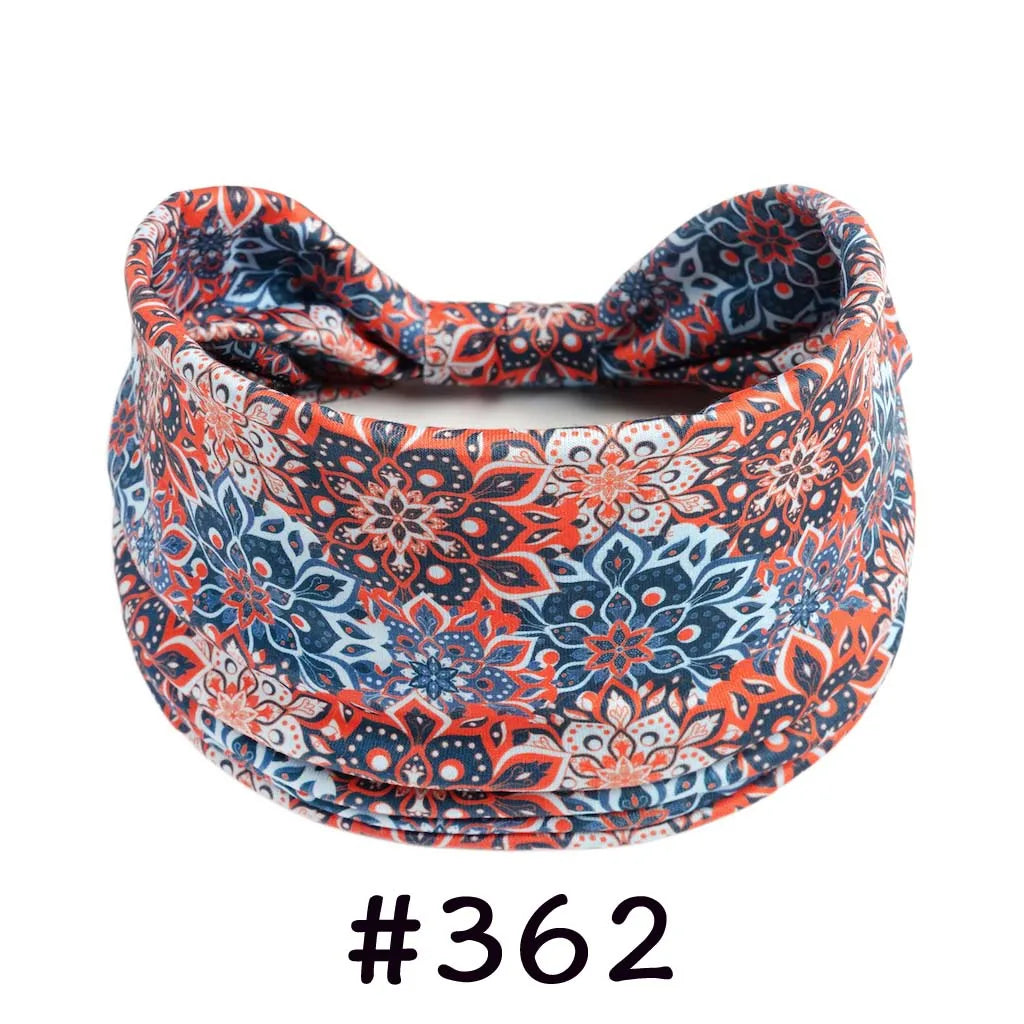 A close-up of a patterned orange and blue boho knotted cotton headband.