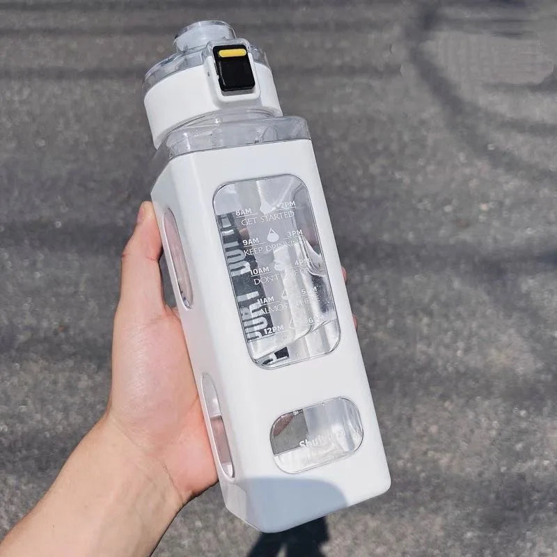 A hand holds a white leakproof sport water bottle with a black cap against a gray outdoor background.