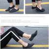 A pair of black breathable boat socks worn by a person, shown in various angles.