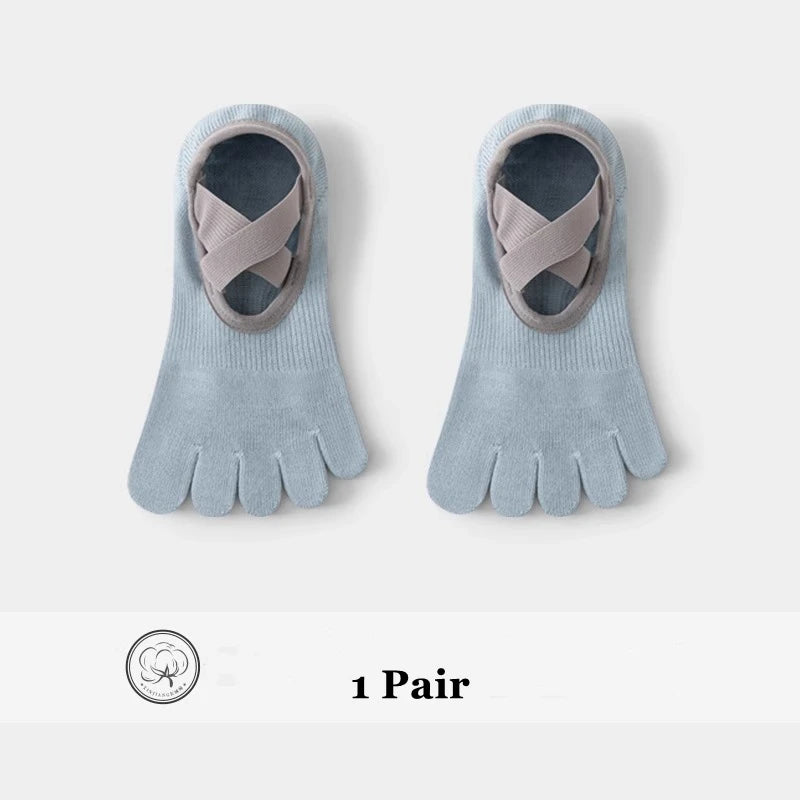 A pair of light blue five-finger invisible yoga and fitness socks with a grey strap detail.