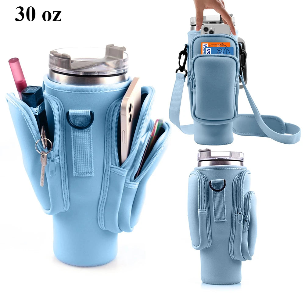 A light blue water bottle carrier bag designed to hold a tumbler and various accessories like a phone and keys.