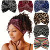 A woman models several bohemian paisley twist headbands in various colors and patterns.