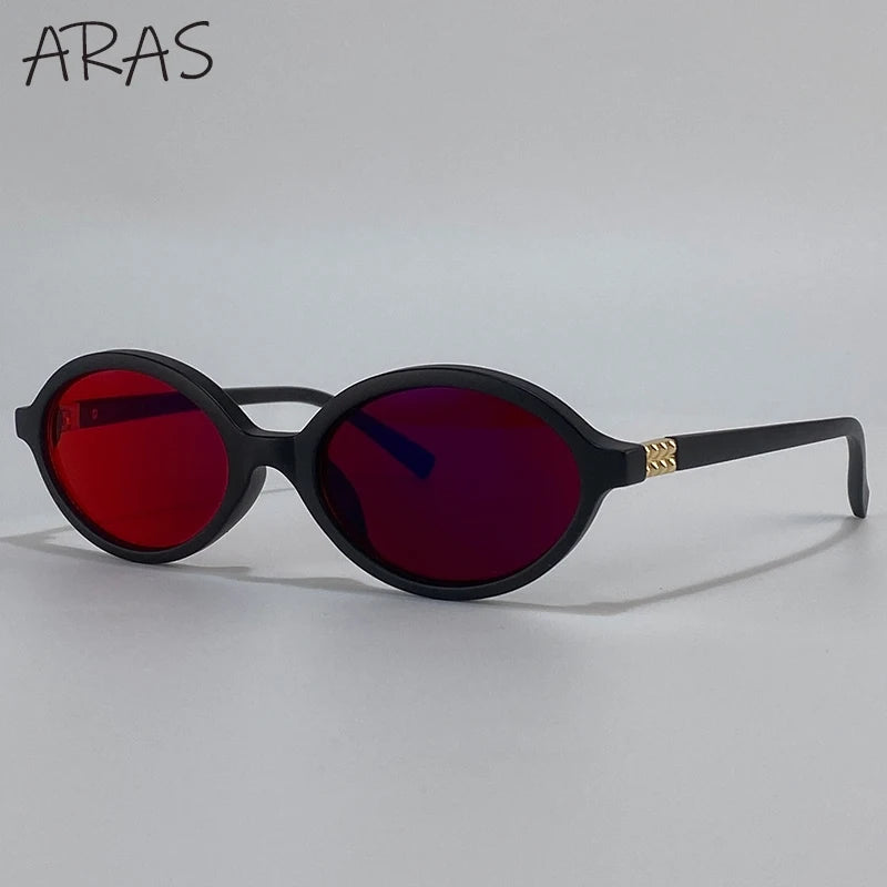 A pair of black round sunglasses with red tinted lenses and gold accents.