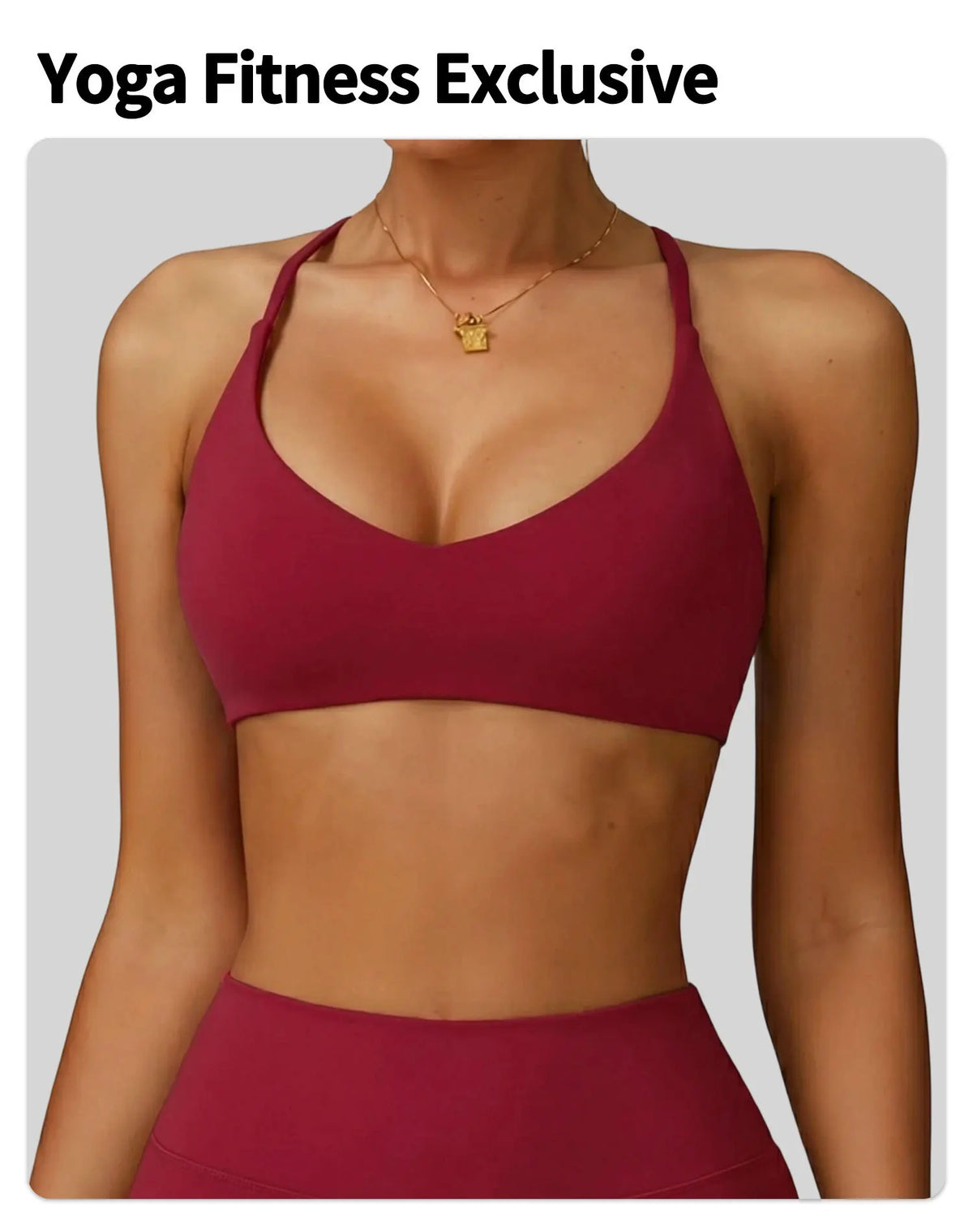 A woman models a maroon yoga fitness sports bra and matching bottoms.