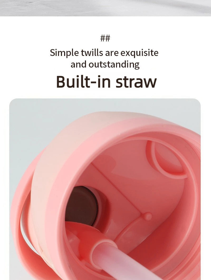 A close-up view of a pink insulated water bottle with a built-in straw feature.