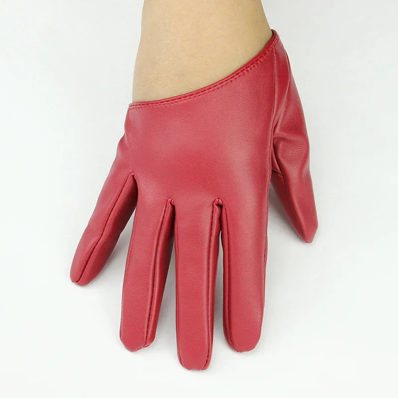 A close-up of a reddish-pink PU leather finger glove worn on a hand.
