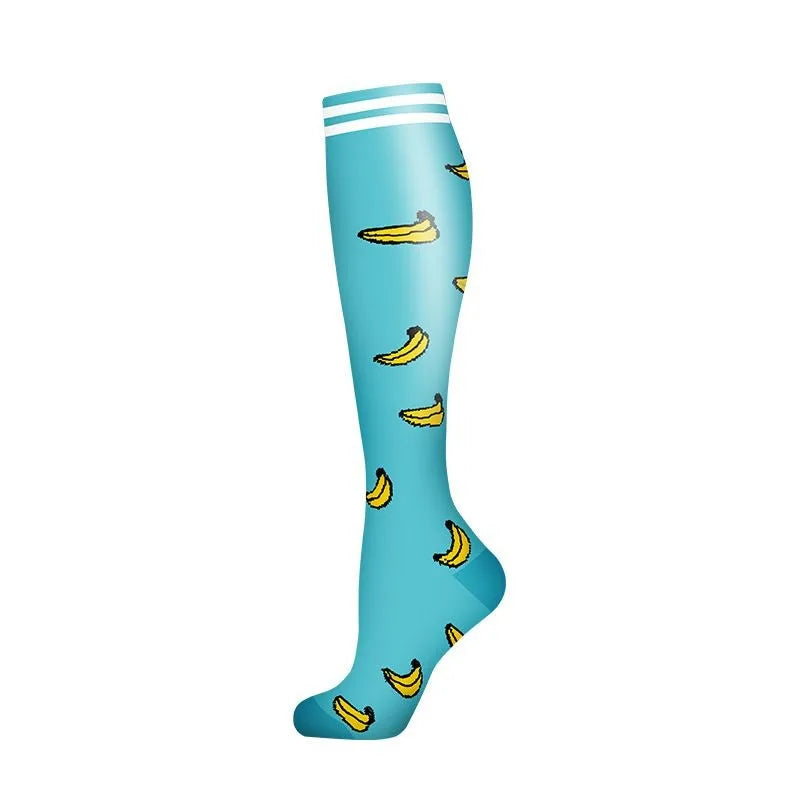 A teal compression sock with white stripes and yellow banana patterns.